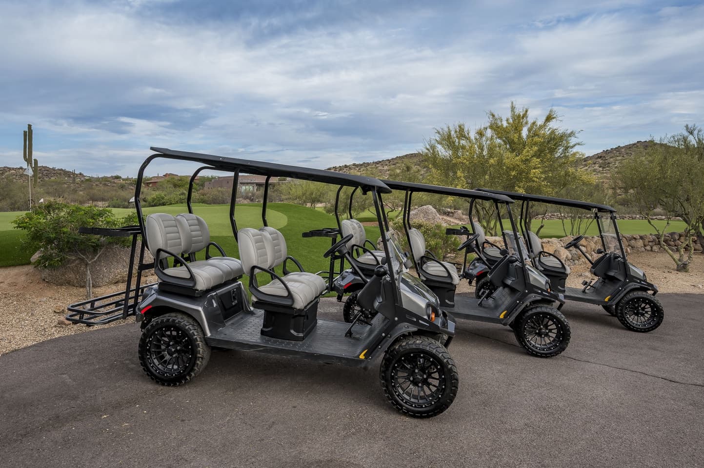 The three four-seat golf carts lined up on the cart path at Saguaro Point