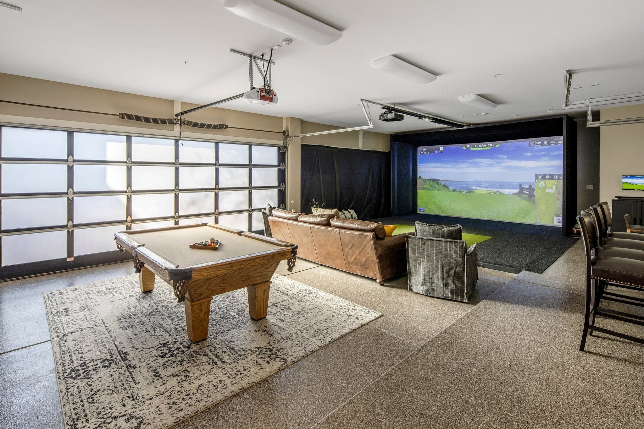 The Saguaro Point game room with billiards table and the Full Swing simulator