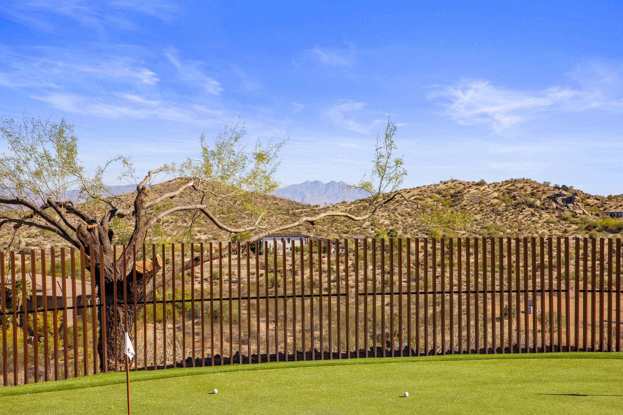 The private practice greens at dusk beneath Pinnacle Peak