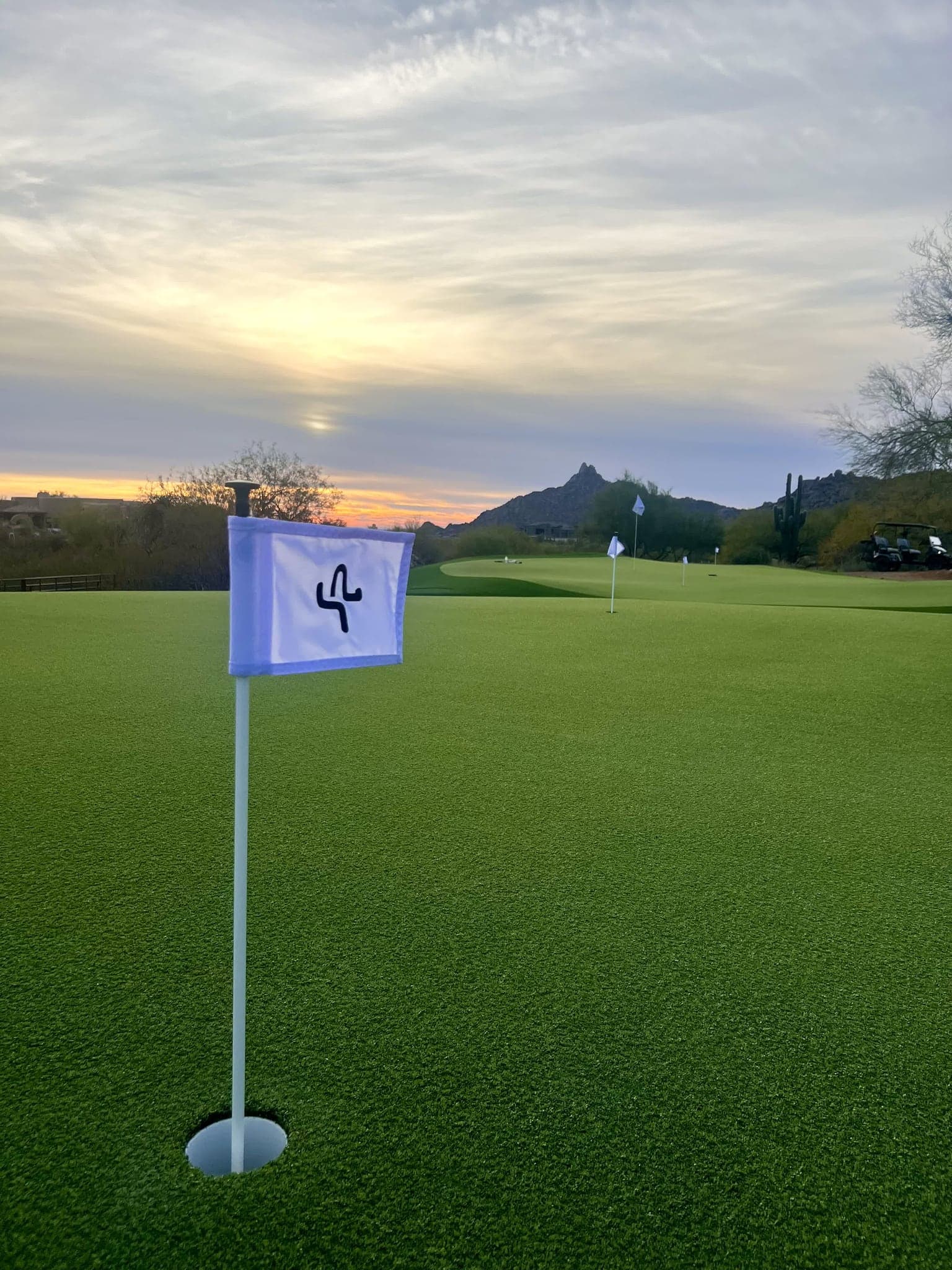 The private Celebrity Greens practice complex at Saguaro Point glowing at sunset