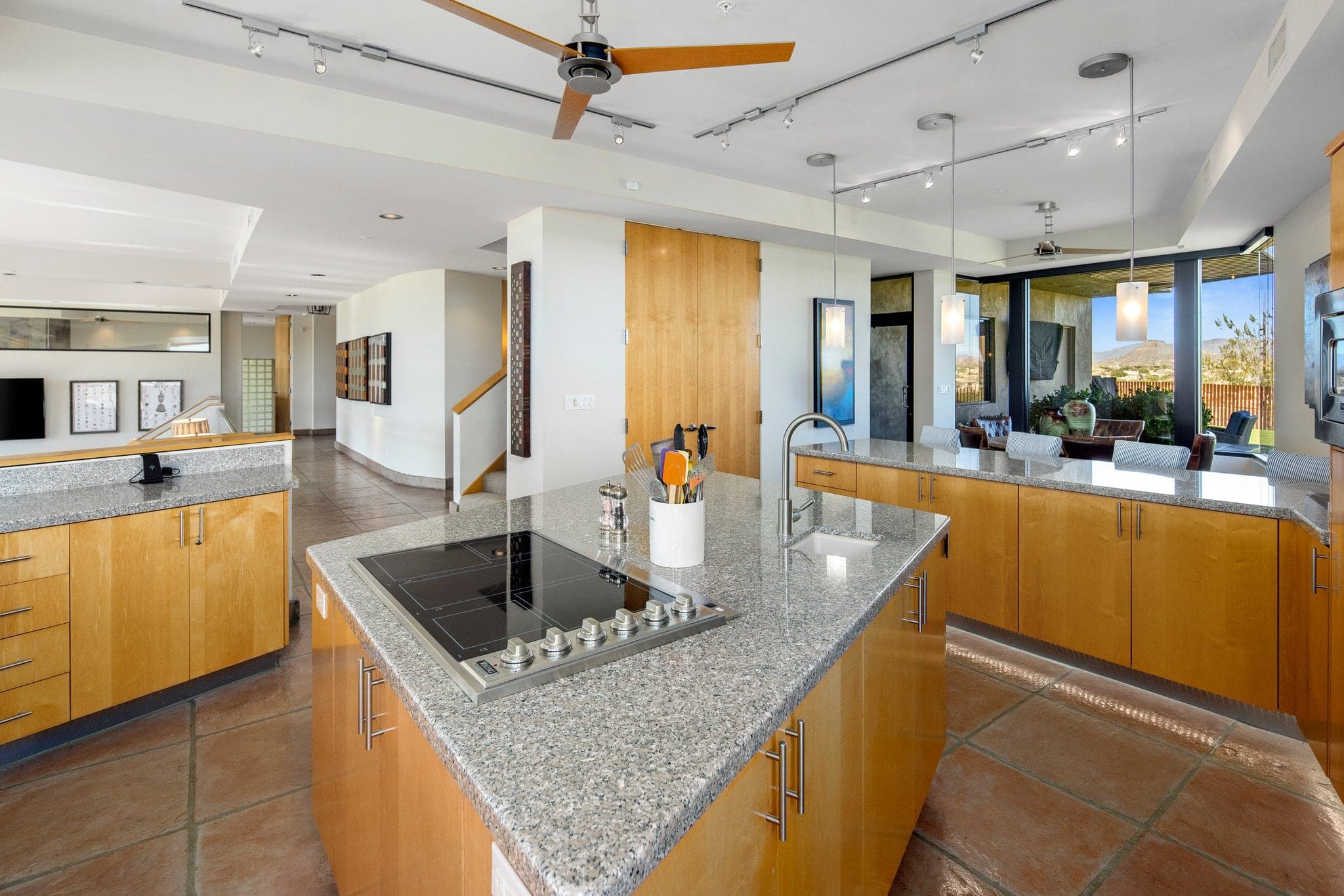 The chef's kitchen with island cooktop and desert views