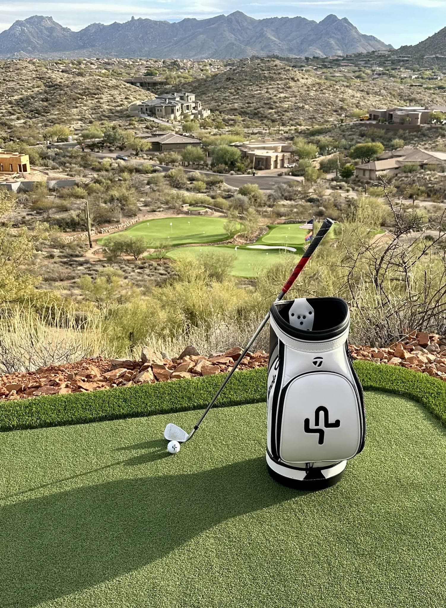 A golf bag standing on the private practice green at Saguaro Point