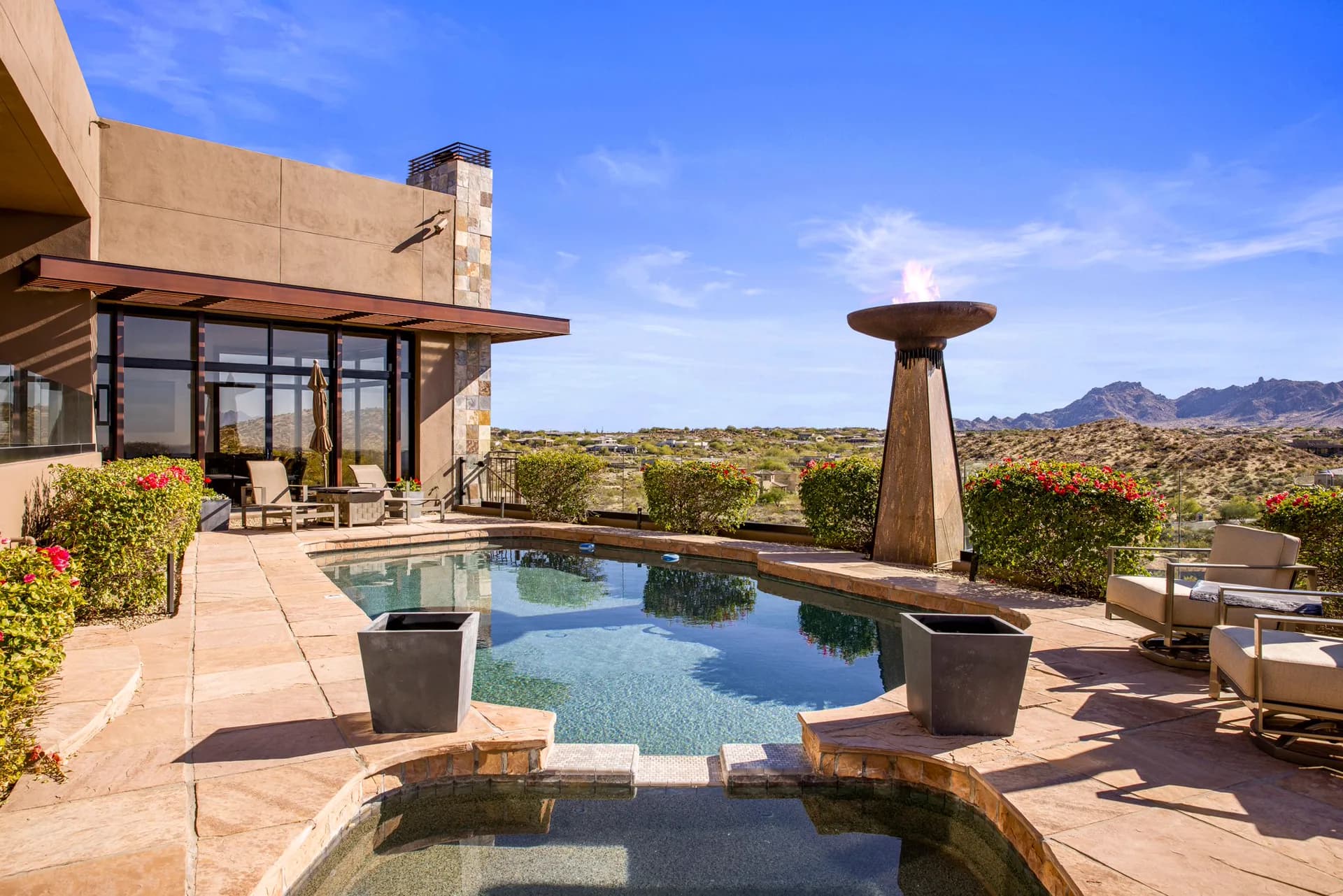 Poolside by day: heated pool, spa, flaming torch fountain, and mountain views