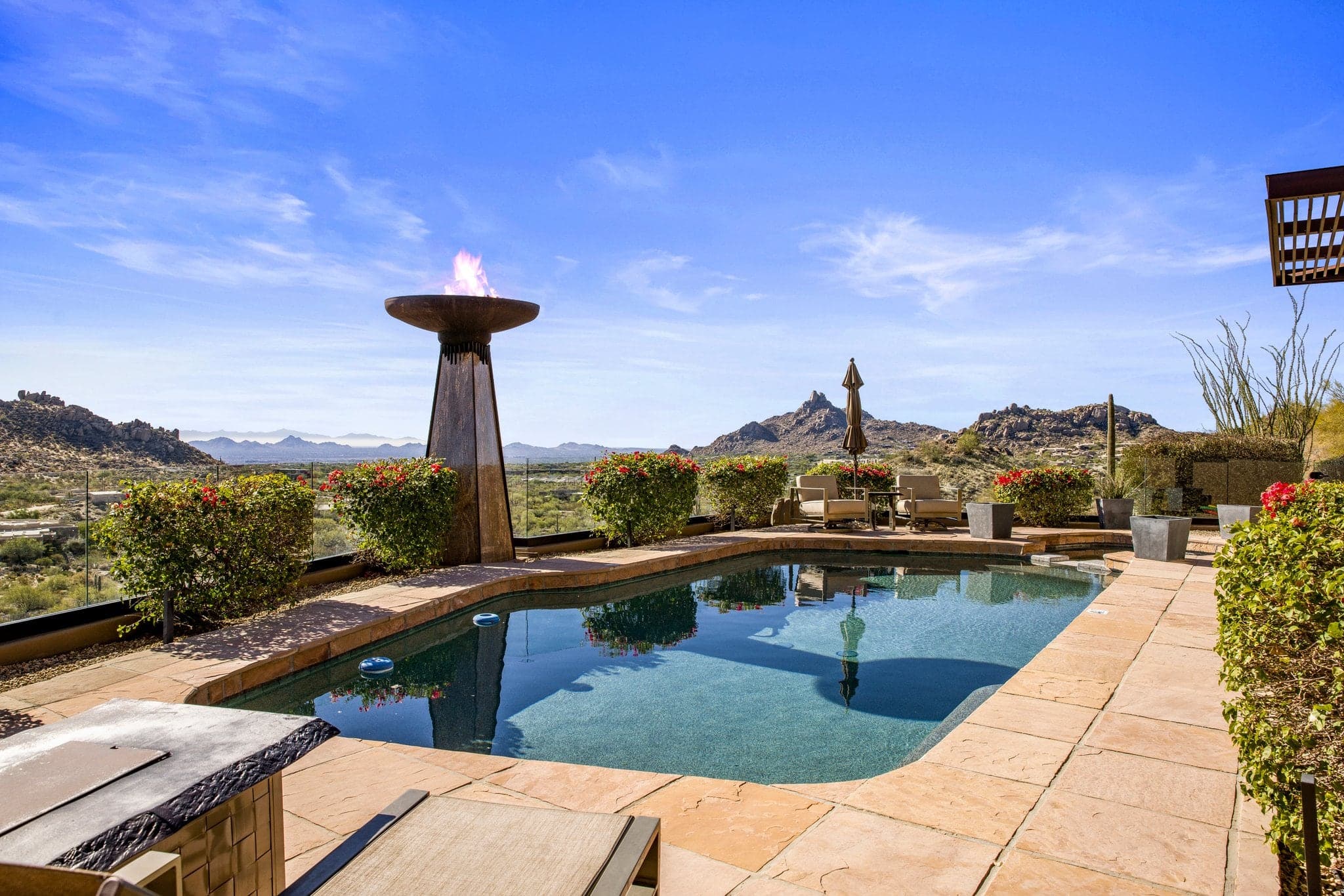 The heated pool and torch fire feature at dusk with Pinnacle Peak beyond