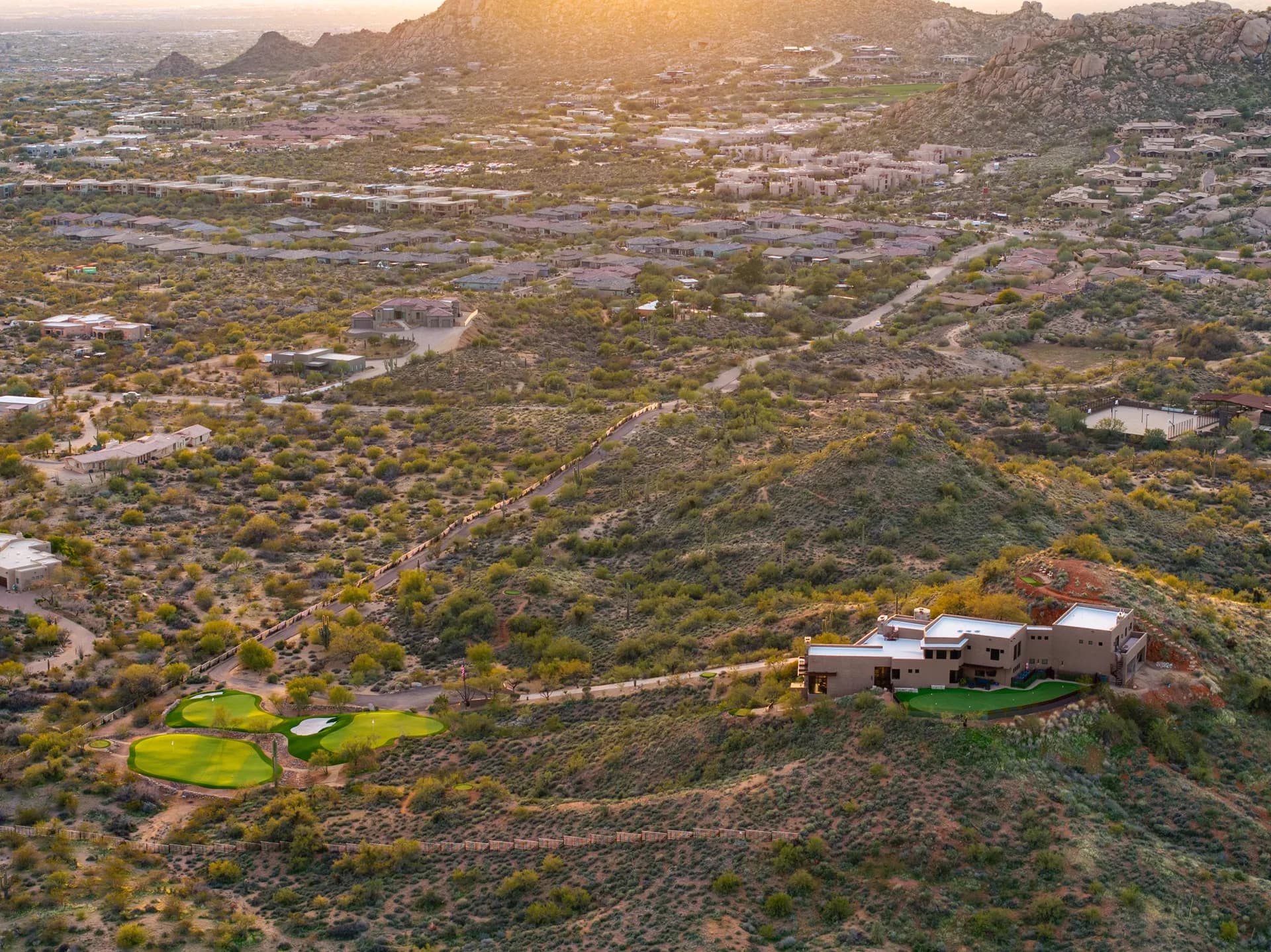 Sunset aerial over the high desert toward the Scottsdale valley from Saguaro Point