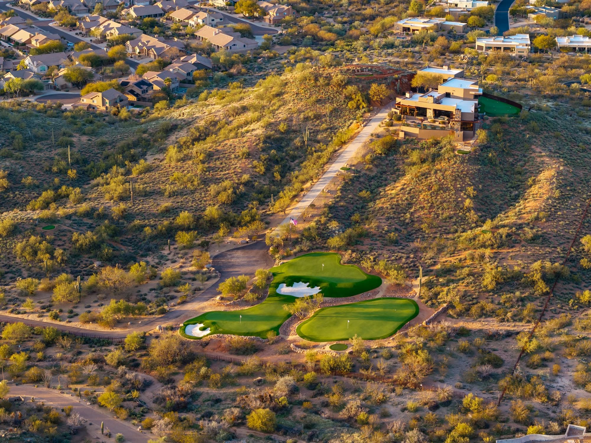 A steep look down on the Saguaro Point golf complex with the estate at upper right