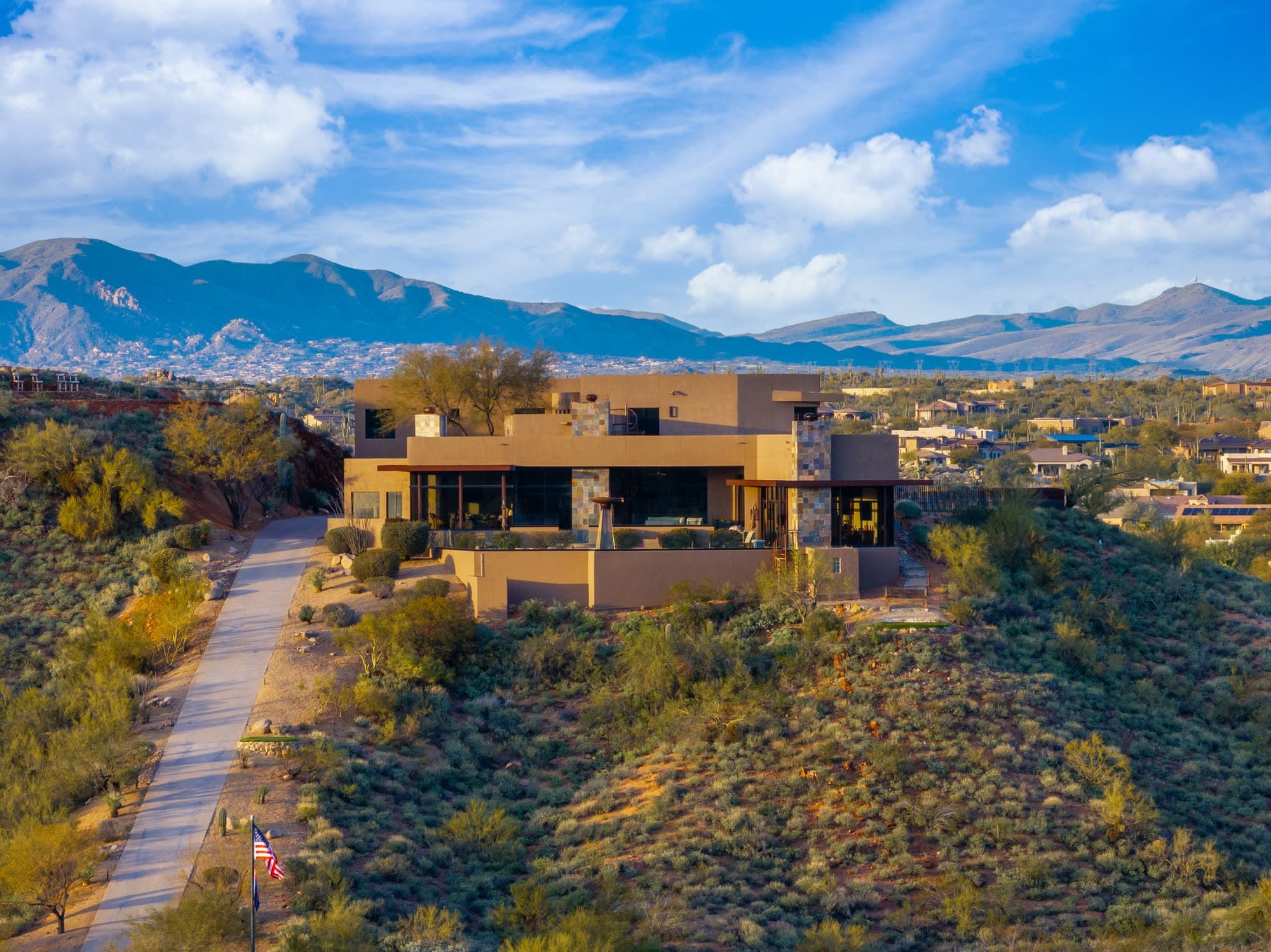 The full estate on its ridge above the private drive, the only house on ten gated acres