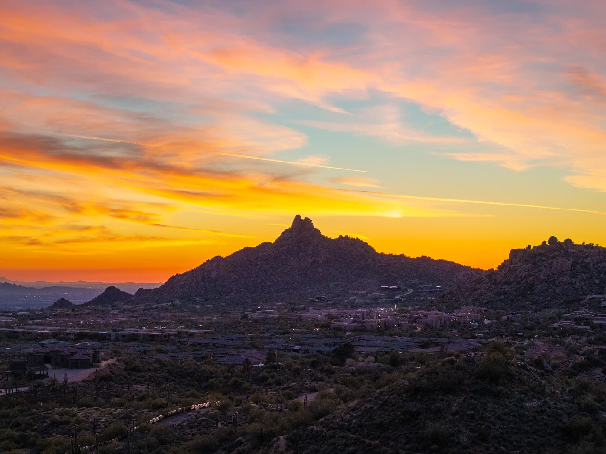 Pinnacle Peak in silhouette against a full orange sunset, the view from North Scottsdale